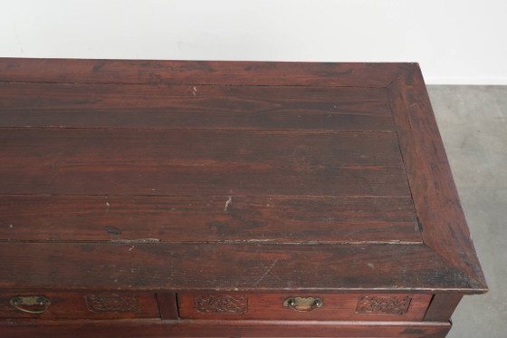 Image 1 of Antique wooden Chinese sideboard from the late 19th century in a beautiful red color with exquisite wood carving.
