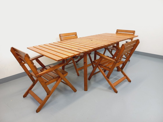 Image 1 of Vintage garden furniture consisting of a table with extensions and 4 wooden armchairs from the 60s