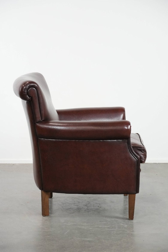 Image 1 of Donkere luxe schapenleren fauteuil/ armchair met een tijdloze uitstraling