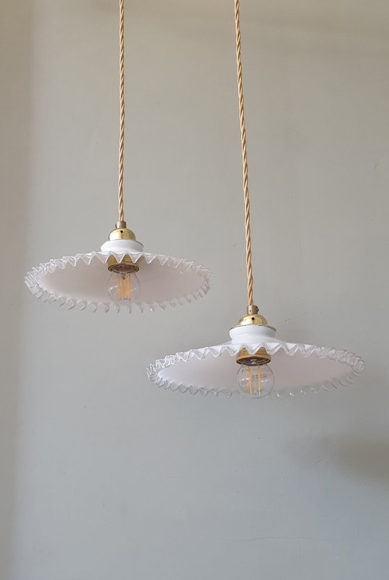 Image 1 of 2 vintage hanglampen van wit opaline glas met een transparante sierrand.