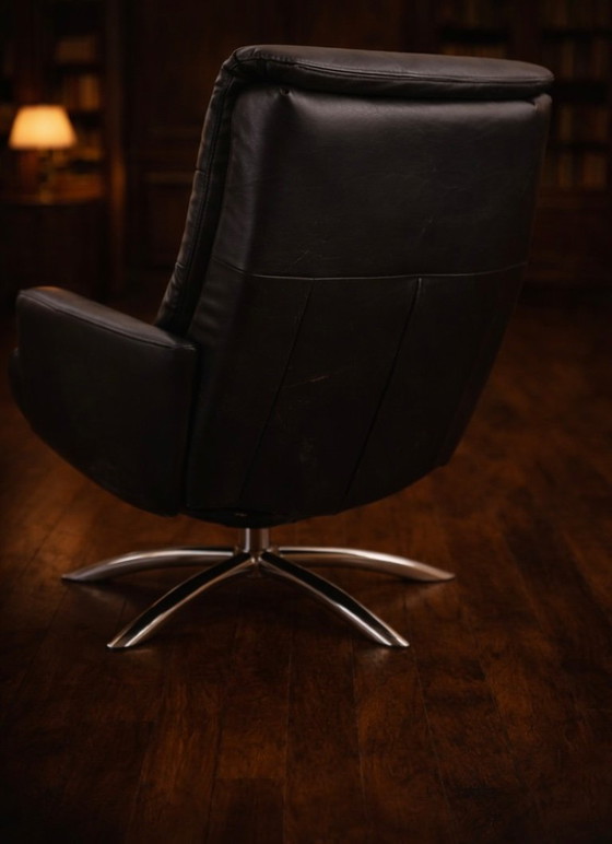Image 1 of Modernist black leather armchair with a chrome X-frame base in a contemporary style, in good condition with minor signs of aging
