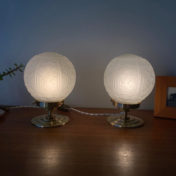 Image 1 of Pair of vintage bedside lamps with antique glass globes and brass bases, circa 1950