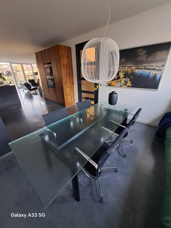 Image 1 of Beautiful combination of Cassina Le Corbusier table with frosted glass and 4 Vitra Eames chairs with black hupsakee upholstery 
