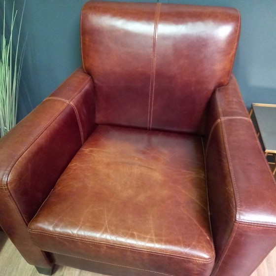 Image 1 of Timeless cowhide leather club armchair, atmospheric and inviting.