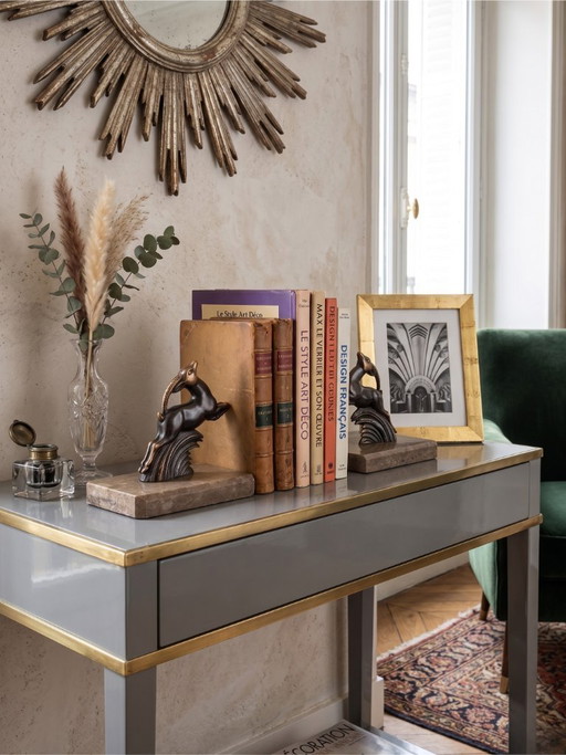 Serre-livres Art Déco en régule patiné – paire animalière stylisée – socles en marbre taupe – années 1930