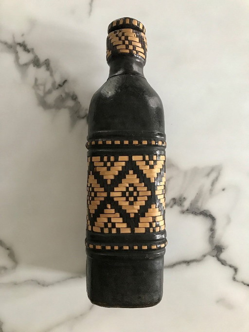 Leather and ethnic raffia bottle