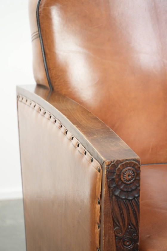 Image 1 of 2 x Prachtige schapenleren Art Deco fauteuil met mooi houtsnijwerk en zwarte biezen