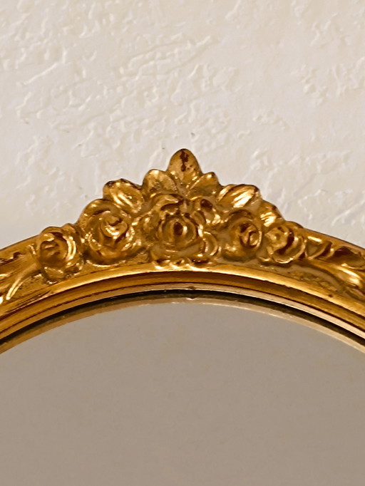 Antique gilded oval mirror