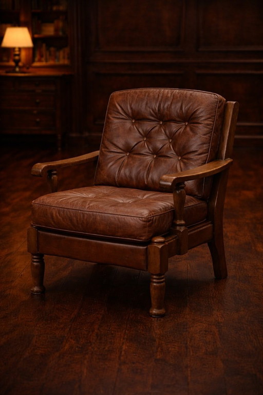 A vintage brown three-piece sofa set in leather with wooden armrests and turned legs, comprising a 1-seater, 2-seater and 3-seat