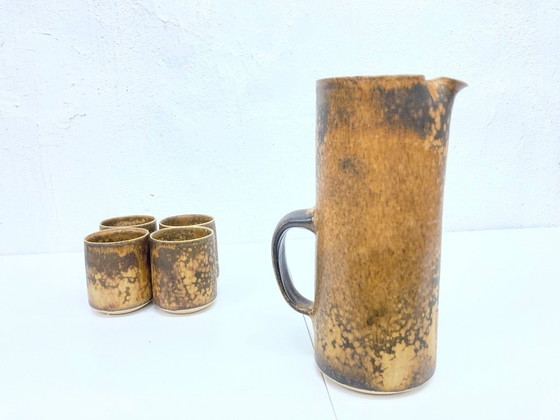 Image 1 of   1 jug and 4 mugs from the 50s 60s by Gotlind Weigel.  Ceramic.  Good used condition. Some chips to the rim