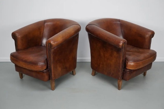 Image 1 of Vintage Nederlandse leren clubfauteuils in cognackleur, set van 2 met voetenbank