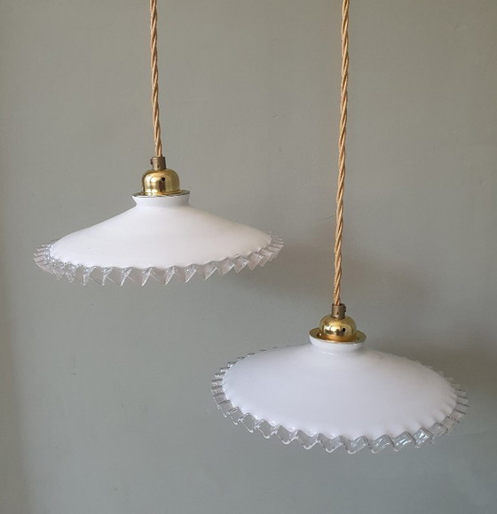 Image 1 of 2 vintage hanglampen van wit opaline glas met een transparante sierrand.