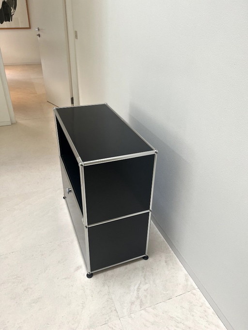 USM Haller Schrank teils offen, teils mit Klappe.