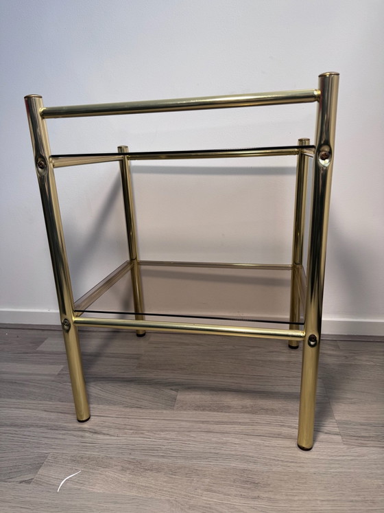 Vintage Regency stule  two-tier side table or nightstand featuring a brass-finished metal frame and smoked (photo 9 of 14)