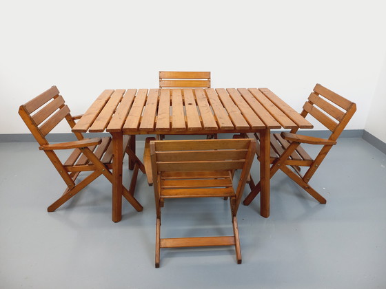 Image 1 of Vintage garden furniture consisting of a table with extensions and 4 wooden armchairs from the 60s