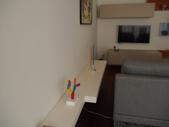 Image 1 of Armadio a ribalta di design con due mensole a muro adiacenti .