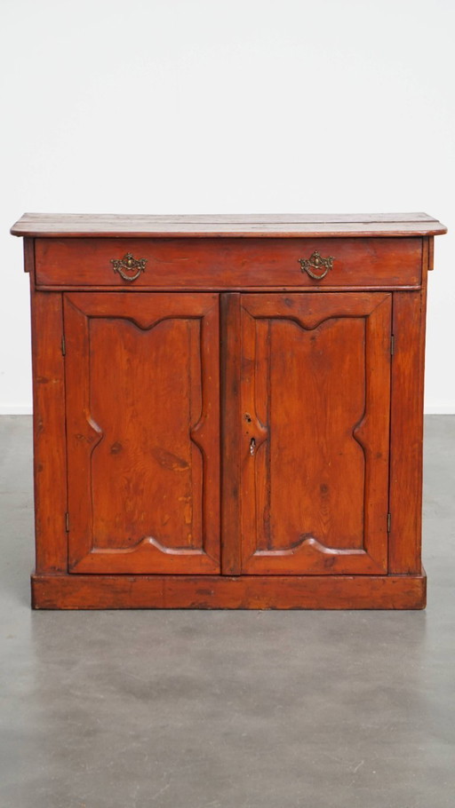 Antique cabinet in a red / brown color with 2 doors and a drawer