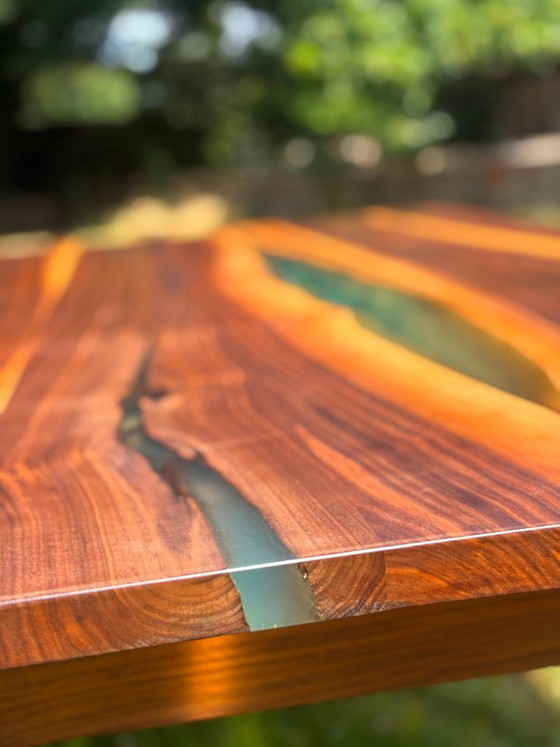 Image 1 of Dining table in American walnut and maple. Handcrafted solid wood extensions and drawers. Live edge for visual depth. Epoxy resi