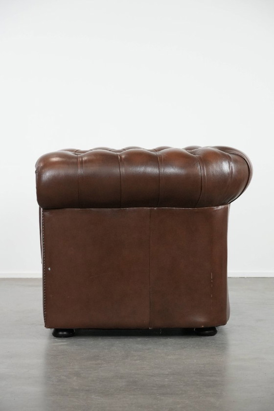 Image 1 of Impresionante sillón Chesterfield de piel de vaca marrón al estilo inglés, acabado con clavos decorativos.