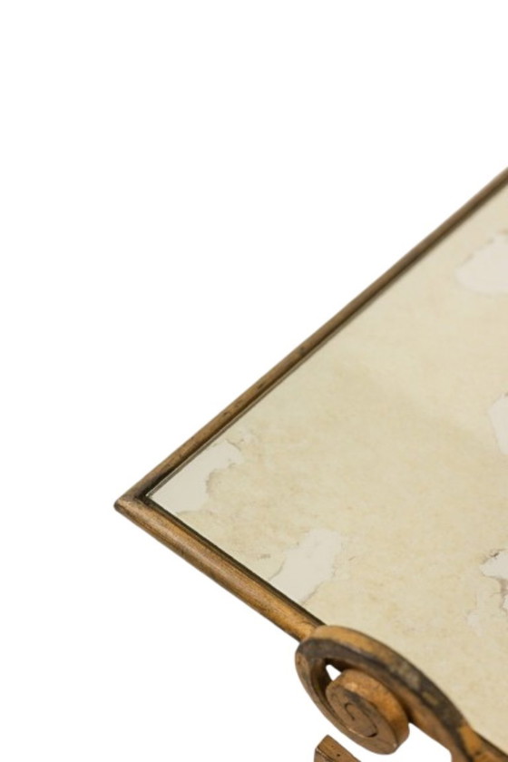 Image 1 of Table basse en fer forgé doré et plateau de verre églomisé. Années 1970