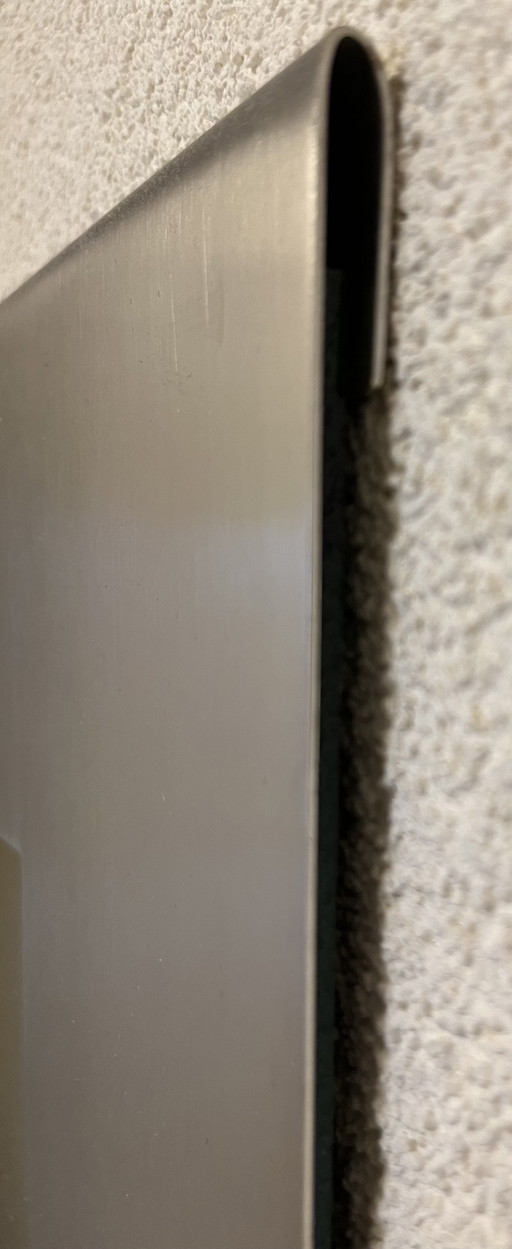 Design mirror in sleek stainless steel frame