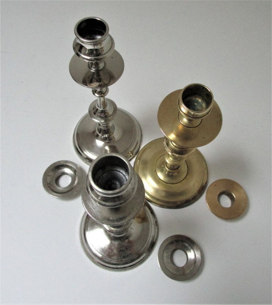 Image 1 of three early 20th-century chrome and brass candlesticks