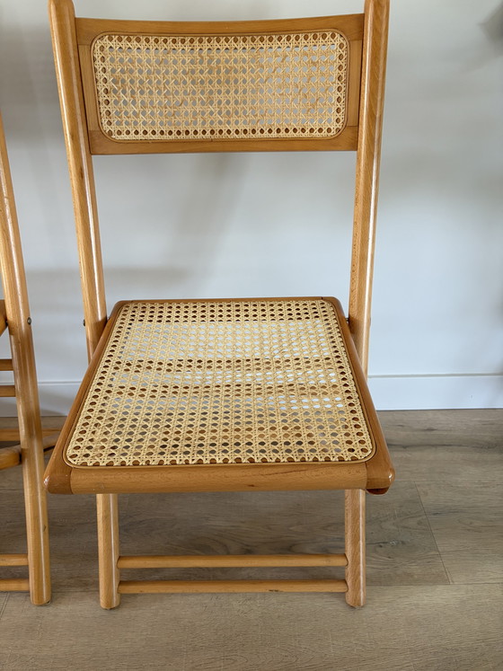 Image 1 of Twee vintage inklapbare houten met webbing stoelen 