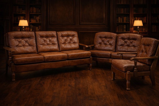 A vintage brown three-piece sofa set in leather with wooden armrests and turned legs, comprising a 1-seater, 2-seater and 3-seat