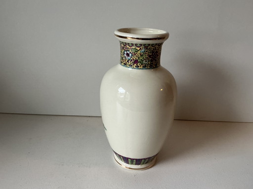 Porcelain vase decorated with a garden scene and figures