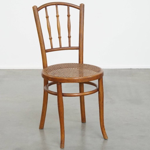 Vintage bistro chair in the style of Thonet with a wicker seat