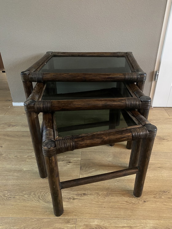 Image 1 of Vintage rattan bamboo nesting tables mimeset smoked glass