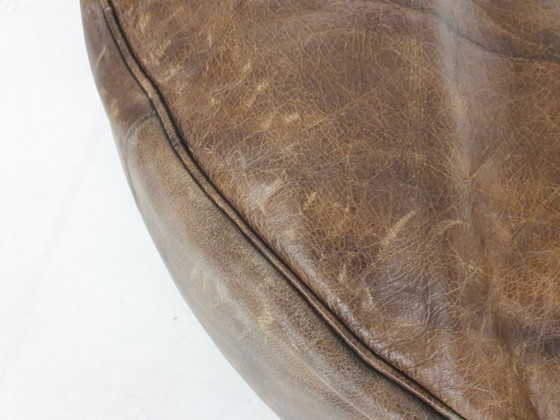 Image 1 of Dark brown leather ottoman. In good vintage condition