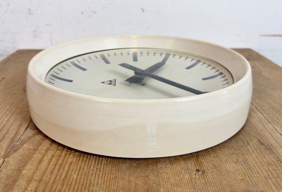 Image 1 of Industriële beige bakelieten fabriekswandklok van Pragotron, jaren 60