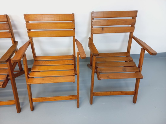 Image 1 of Vintage garden furniture consisting of a table with extensions and 4 wooden armchairs from the 60s