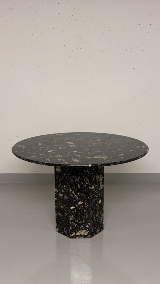 Exclusive design table made of black marble - round with facetted base, timeless