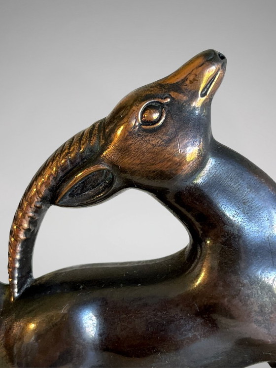 Image 1 of Serre-livres Art Déco en régule patiné – paire animalière stylisée – socles en marbre taupe – années 1930