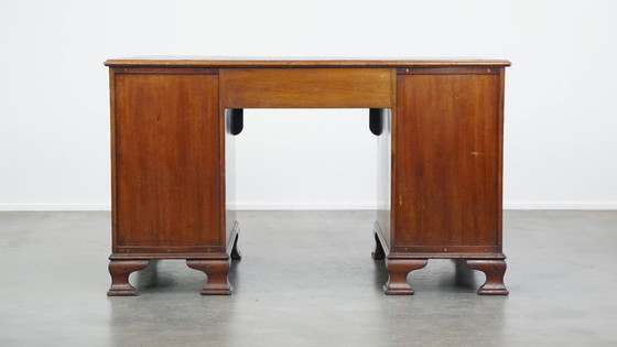 Image 1 of Luxurious and antique English wooden desk from the late 19th century with a leather top and a curved front.