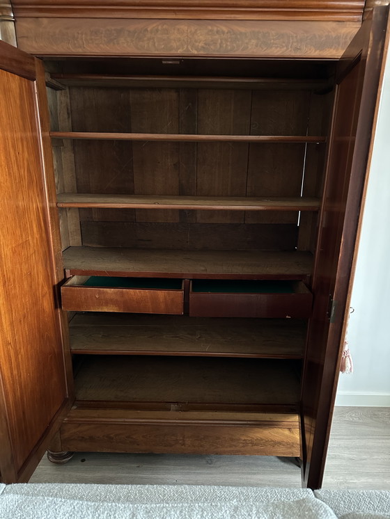 Image 1 of Armario antiguo de madera con detalles ornamentales.