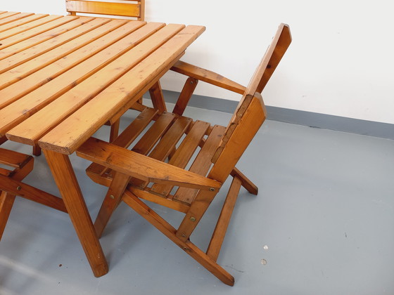Image 1 of Vintage garden furniture consisting of a table with extensions and 4 wooden armchairs from the 60s