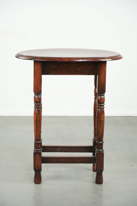 Image 1 of Antique oval English oak side table from the early 20th century with beautiful colors