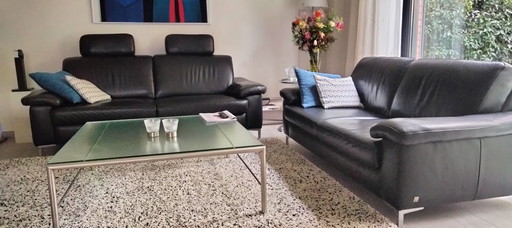 2 Musterring black leather sofas with stainless steel base
