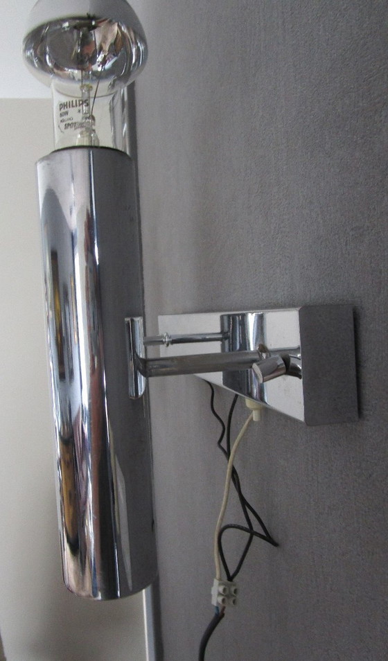 Image 1 of This chrome-colored space-age wall lamp is attributed to designer Gaetano Sciolari from the 1970s.
