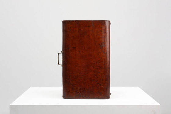 Image 1 of Vintage brown leather suitcase with copper details, China 1900s