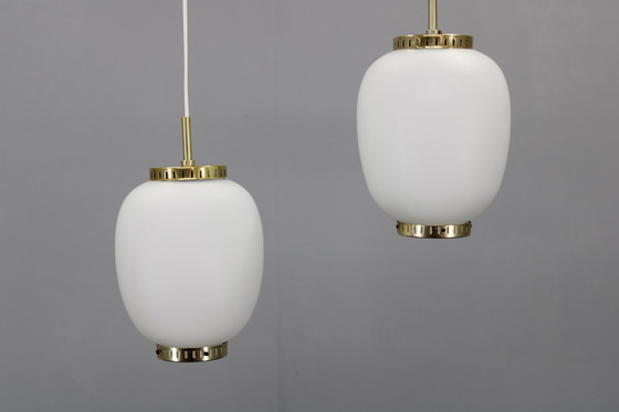 Image 1 of 1970 Karlby Paire de pendentifs en verre opalin et laiton par Lyfa, Danemark