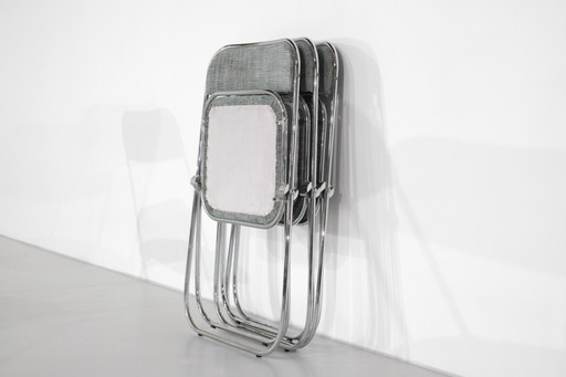 Juego de 9 sillas plegables cromadas con tela de los años 70