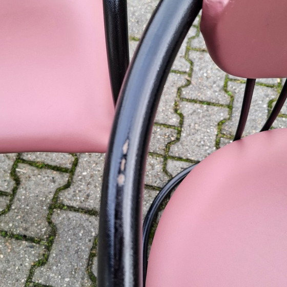 Image 1 of This is a set of four vintage 'Memphis' style chairs with a black metal frame and burgundy upholstery.