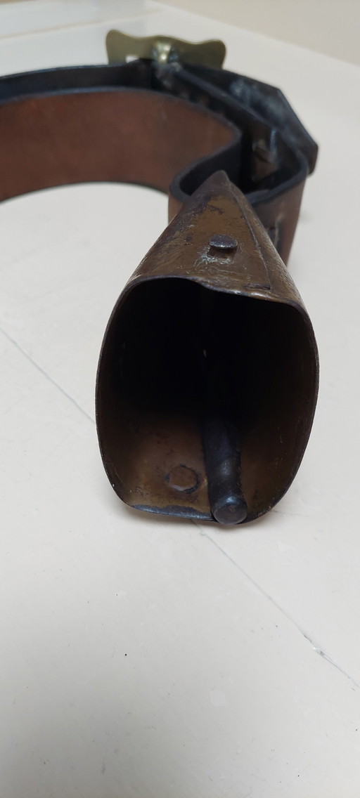 Antique cowbell with leather strap