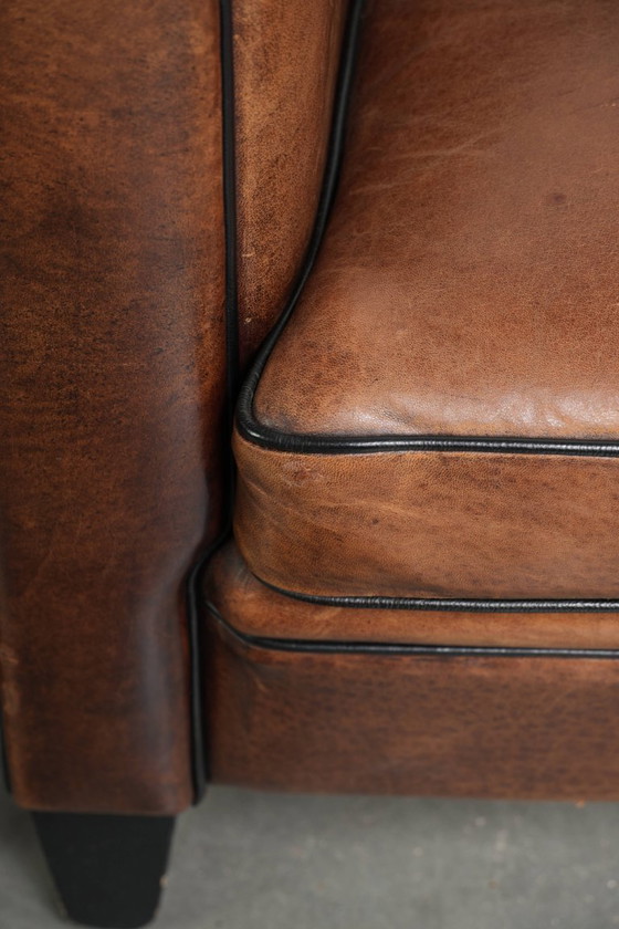 Image 1 of 2x schapenleren Art Deco design clubfauteuil met een mooi patina, zwarte biezen en mooie kleuren
