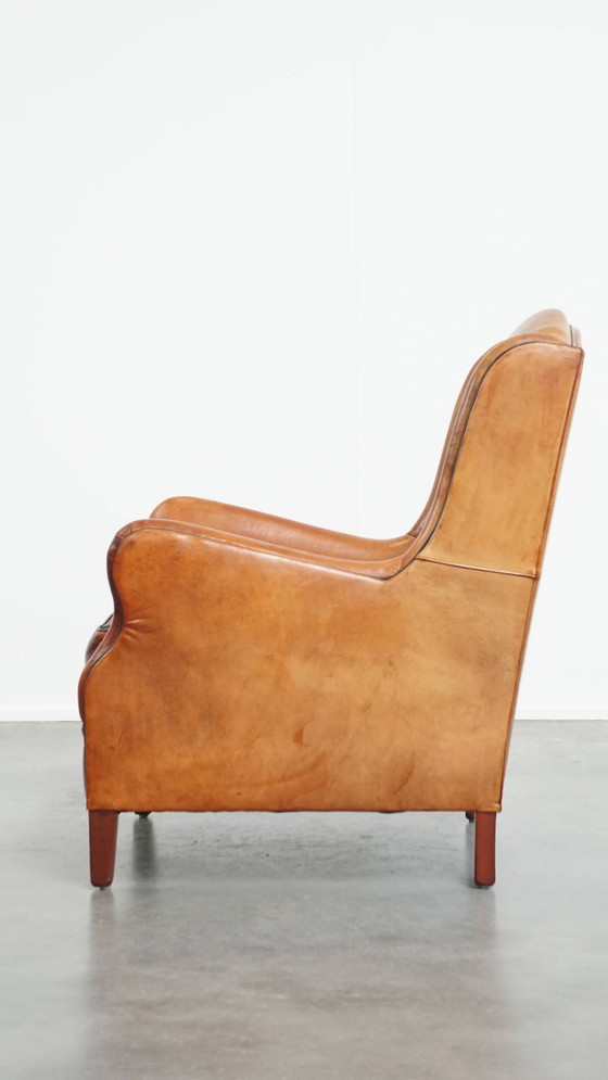 Image 1 of Schapenleren armchair met hoge rug en zwarte biezen 