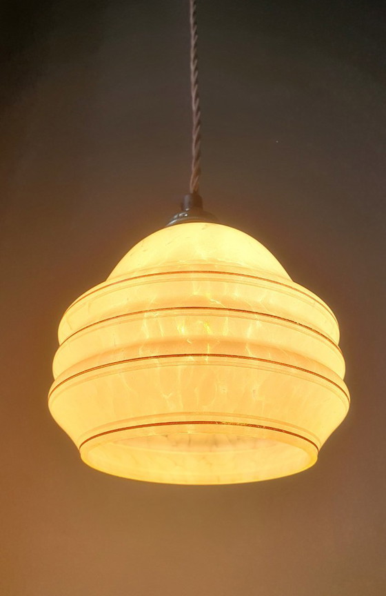Image 1 of Vintage hanglamp - amberkleurig glas met spots en goudkleurige biezen.